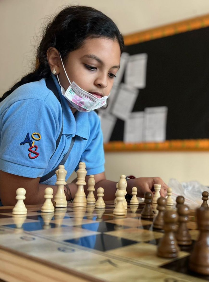 Young student of Abu Dhabi International School playing chess